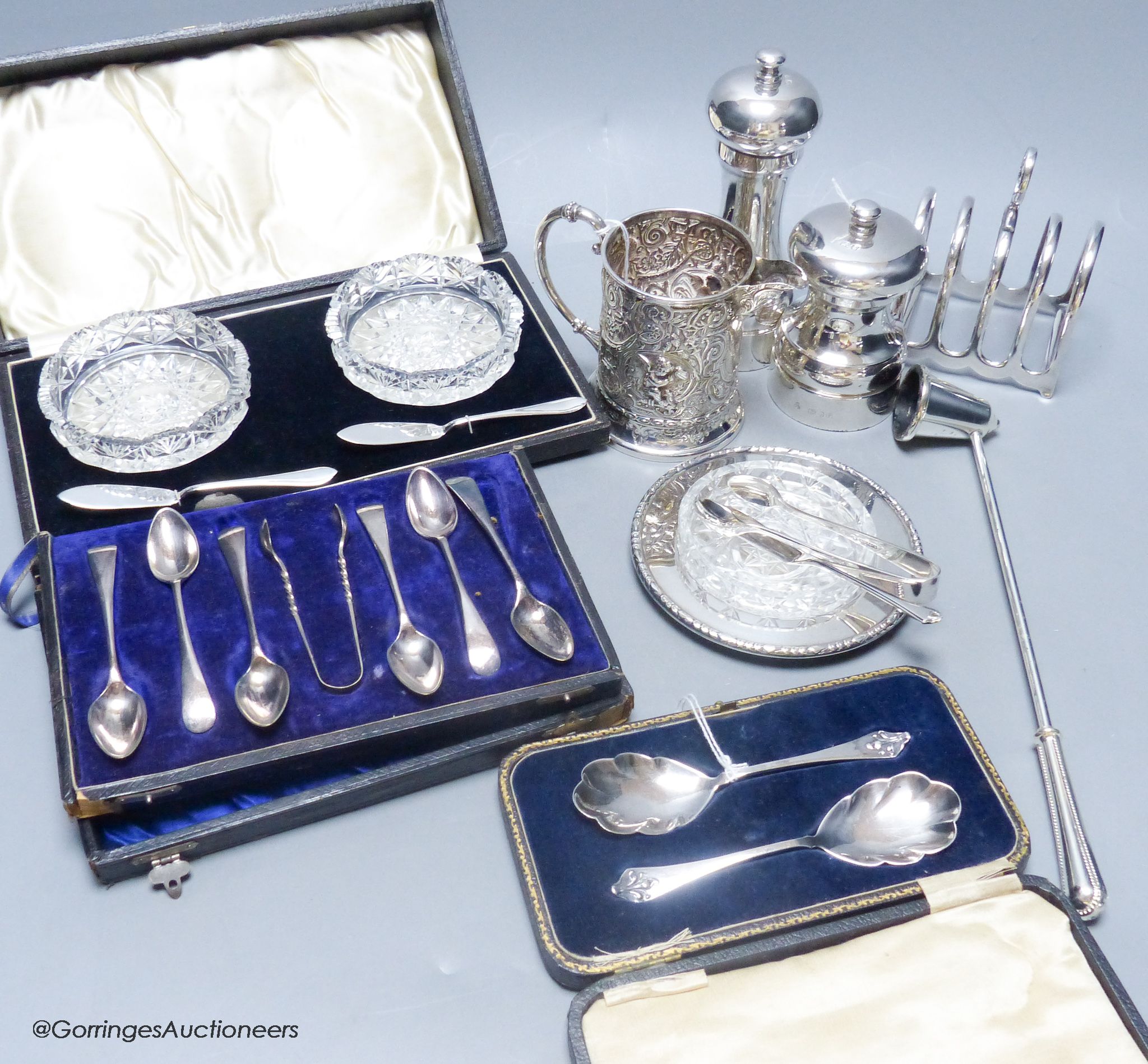 Two silver capstan pepper mills, a cased pair of silver preserve spoons, a Mappin & Webb silver and cut glass butter dish and knife and sundry small plated items